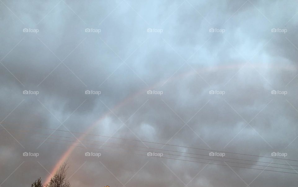 Beautiful Rainbow seen through the clouds in the sky