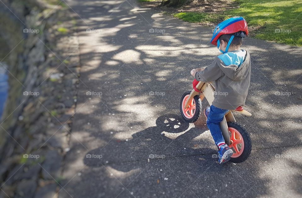 Little boy riding bicycle in park
