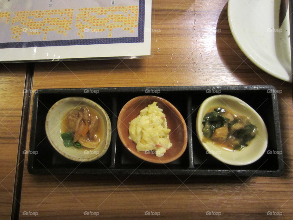 Seafood Appetizers, Mussels.  Japanese Food at Lion Pub, Ginza, Tokyo, Japan. Three flavors on rectangular plate with chopsticks. Modern Cuisine.