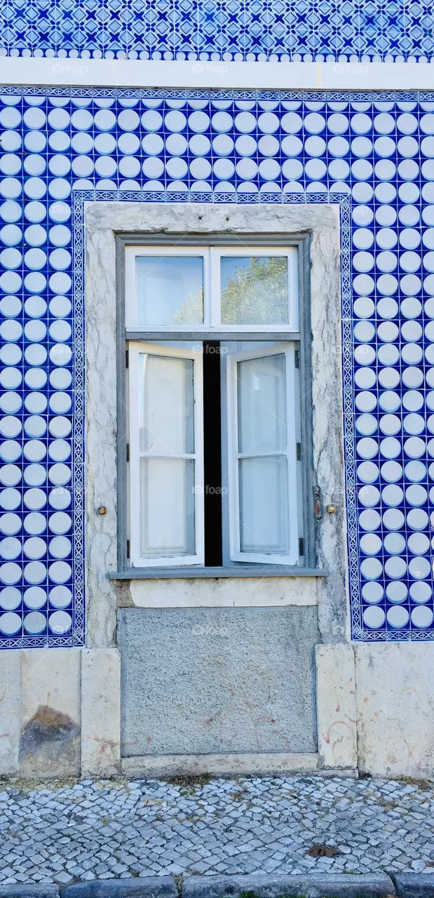 Lisbon, Portugal, front shot of window and typical buildings tiled with famous azulejos ceramic tiles 