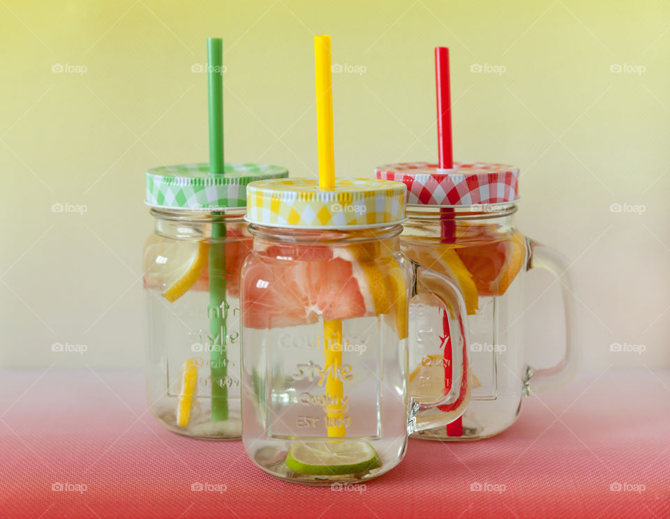 Homemade citrus lemonade in three glass jars