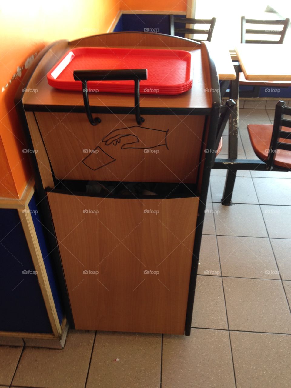 Retro faux wood finished trash can in a fast food restaurant