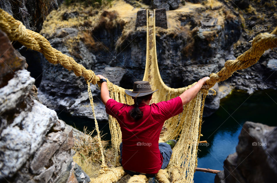 Traveller on a rope bridge