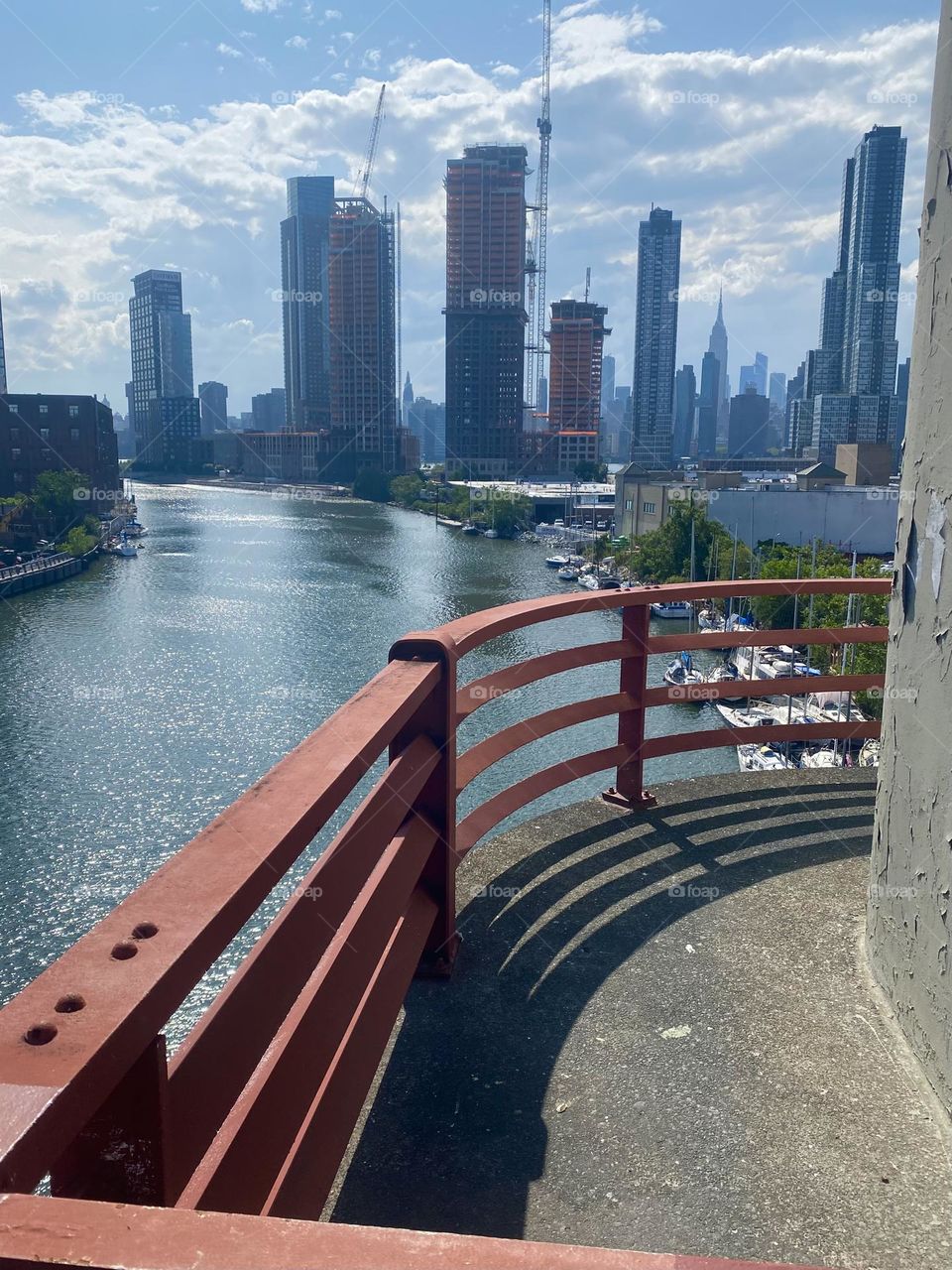 This streamlined architectural design on top of the “Pulaski Bridge” at “Newtown Creek” protects the wanton public from being too curious or stepping too far. The panoramic view of NYC from up here is simply spectacular. 2023. Hypnotic Productions