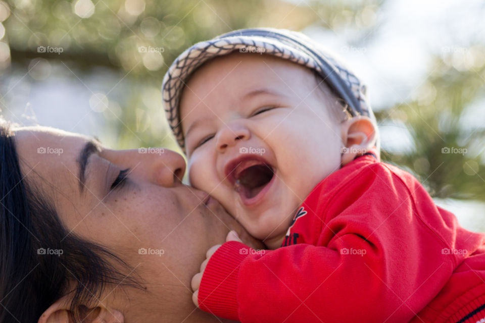 Close-up of mother kissing her baby boy