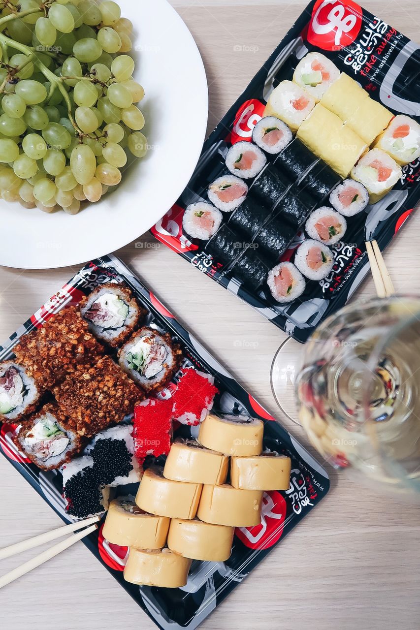 Tasty sushi with wine on the table 