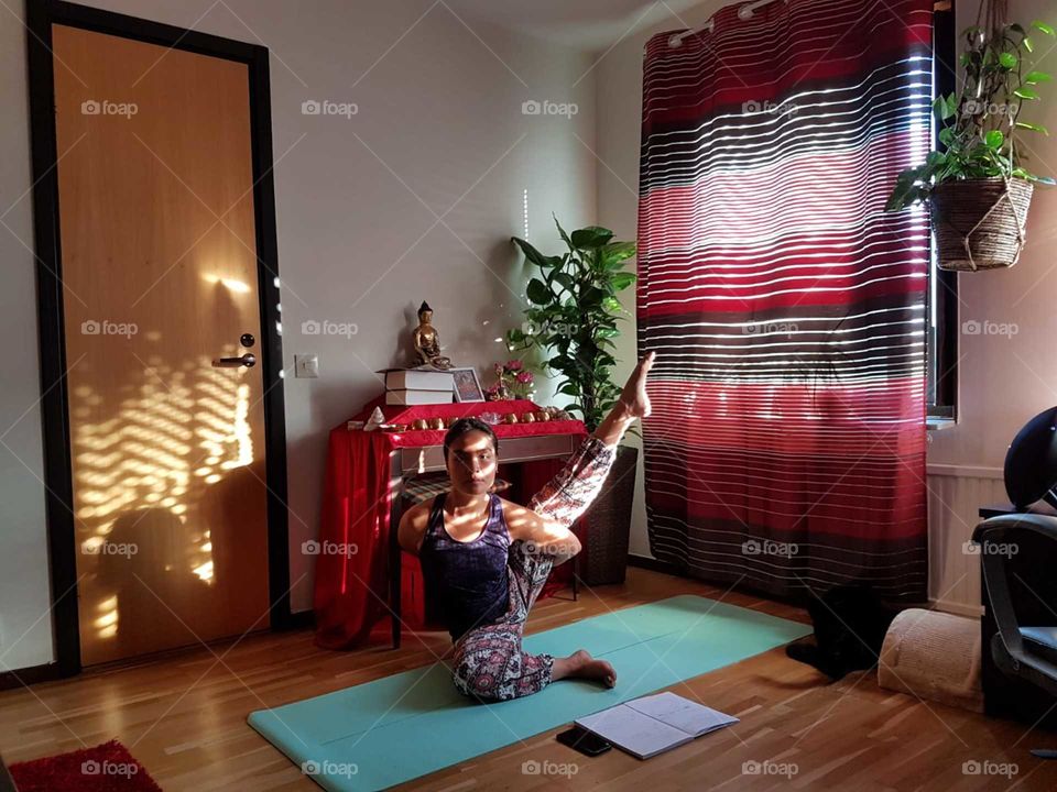Self practice yoga indoor. Buddha corner.