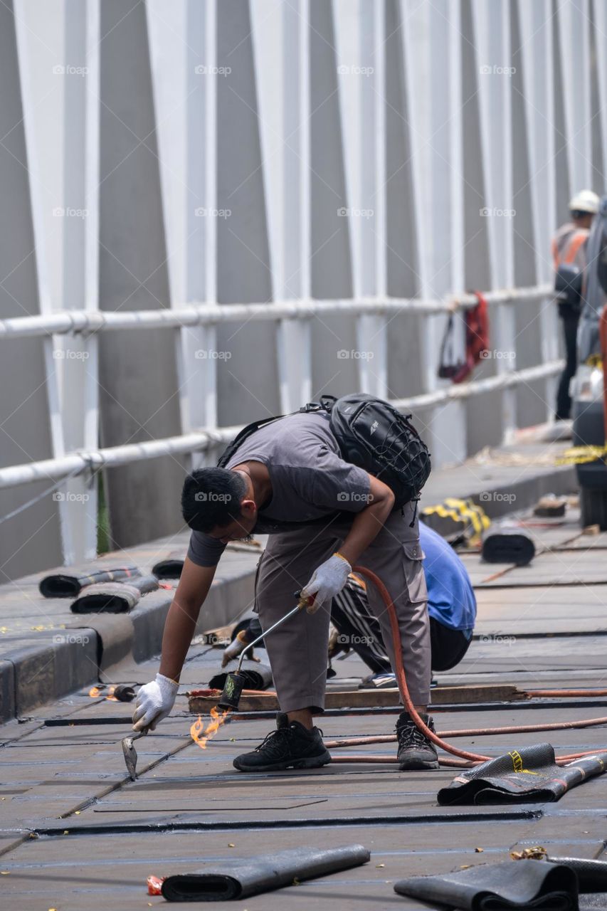 workers are renovating a bridge