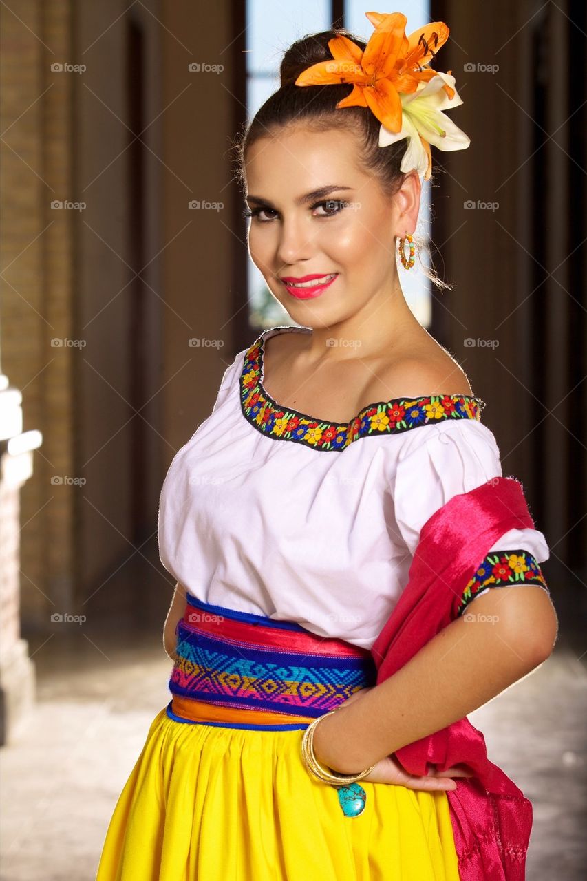 Young woman dressed in folkloric typical festive mexican dress