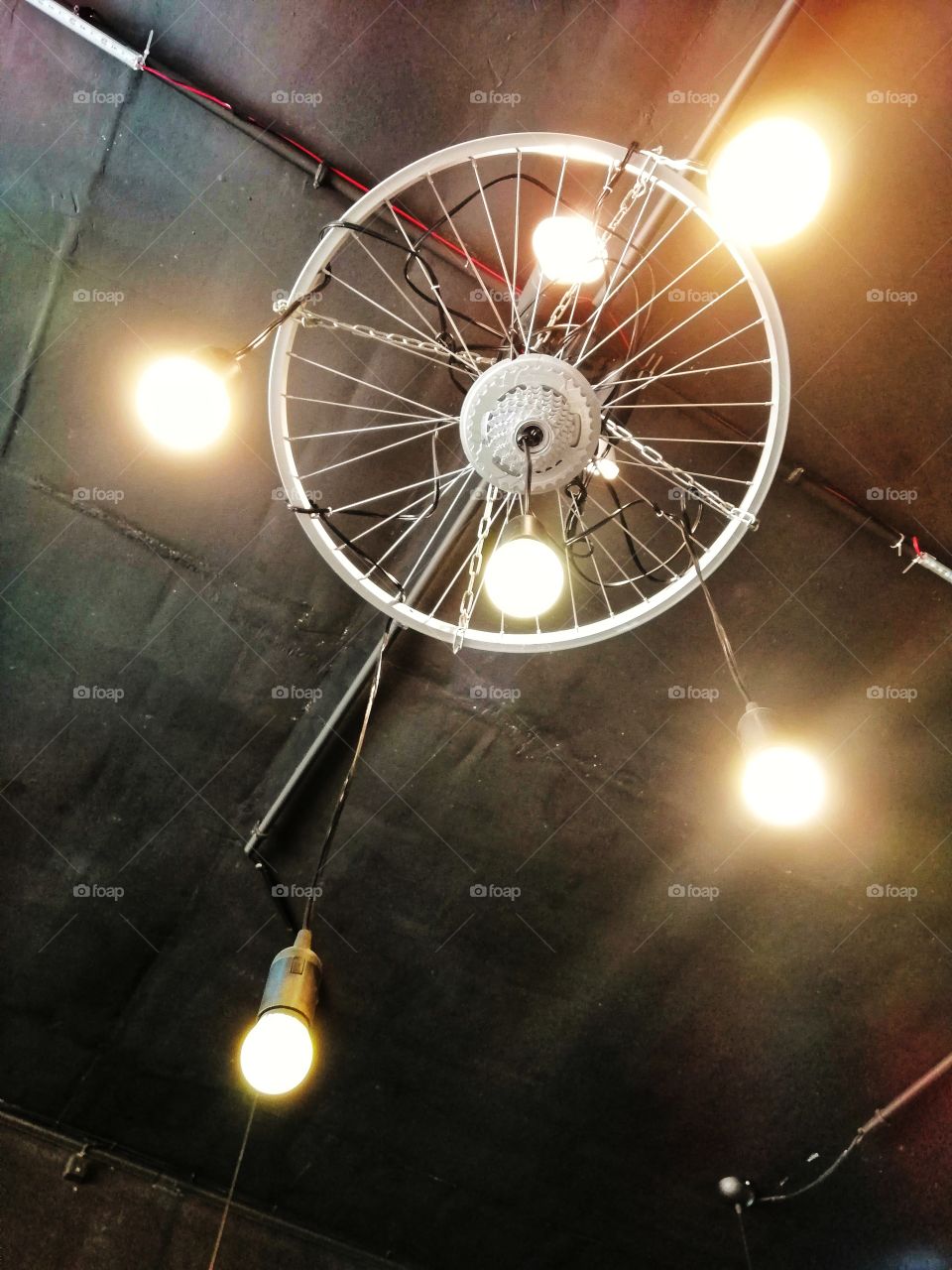 A modified hanging light with the use of bicycle wheel.