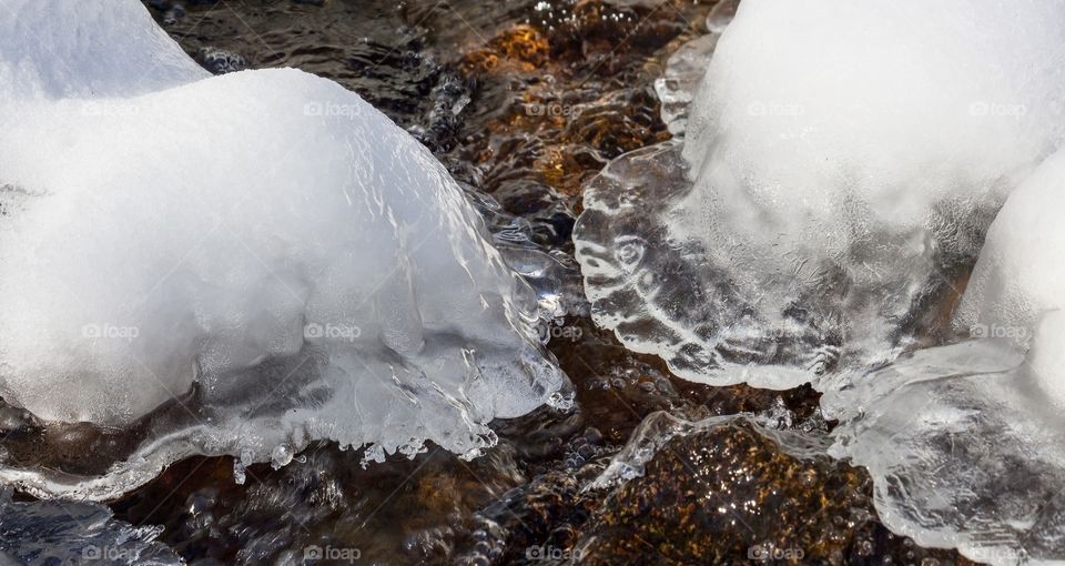 Beautiful shapes sculpted from the winter in a mountain stream