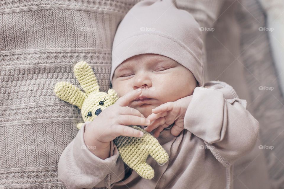 newborn baby sleeping with a toy