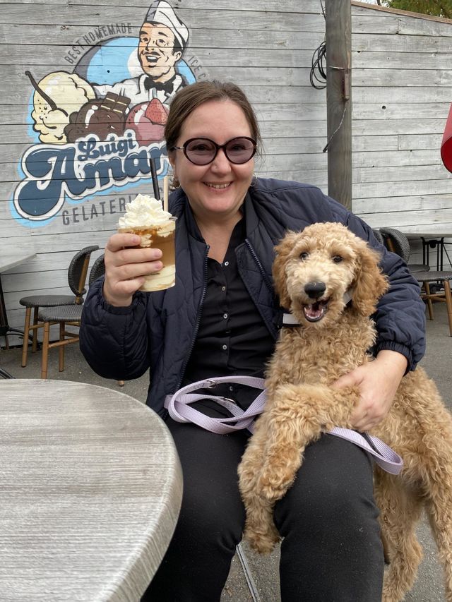 My poodle dog Phoebe and I enjoying an iced coffee. She is licking her little mouth right now. We had a lot of fun at the zoo that day. Phoebe was just 5 months old on the photo. It was a very sunny day, hence the sunglasses on my nose. 