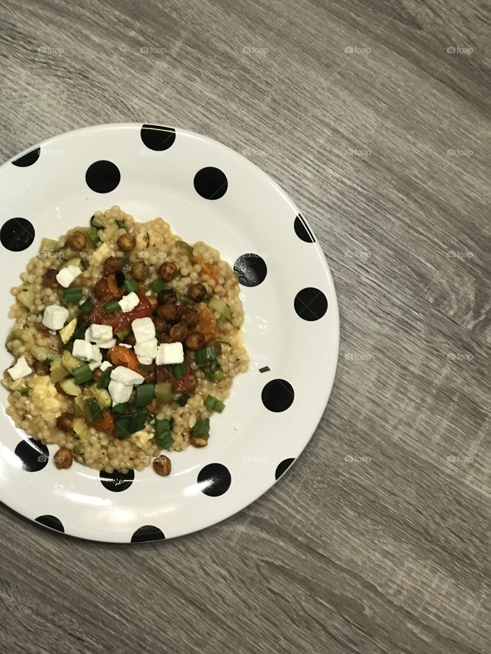 Couscous dish plates with cheese and vegetables