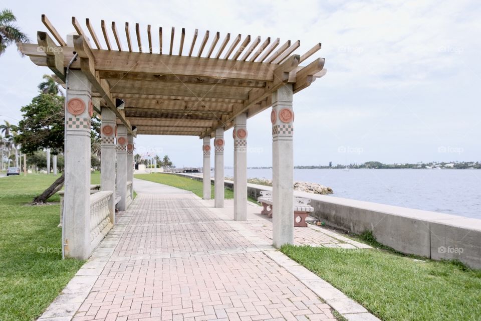 Covered benches on walkway along seawall