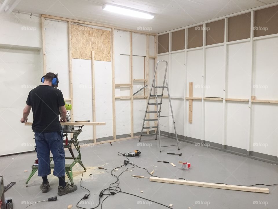 Counstruction site, man building a photostudio in Sweden.