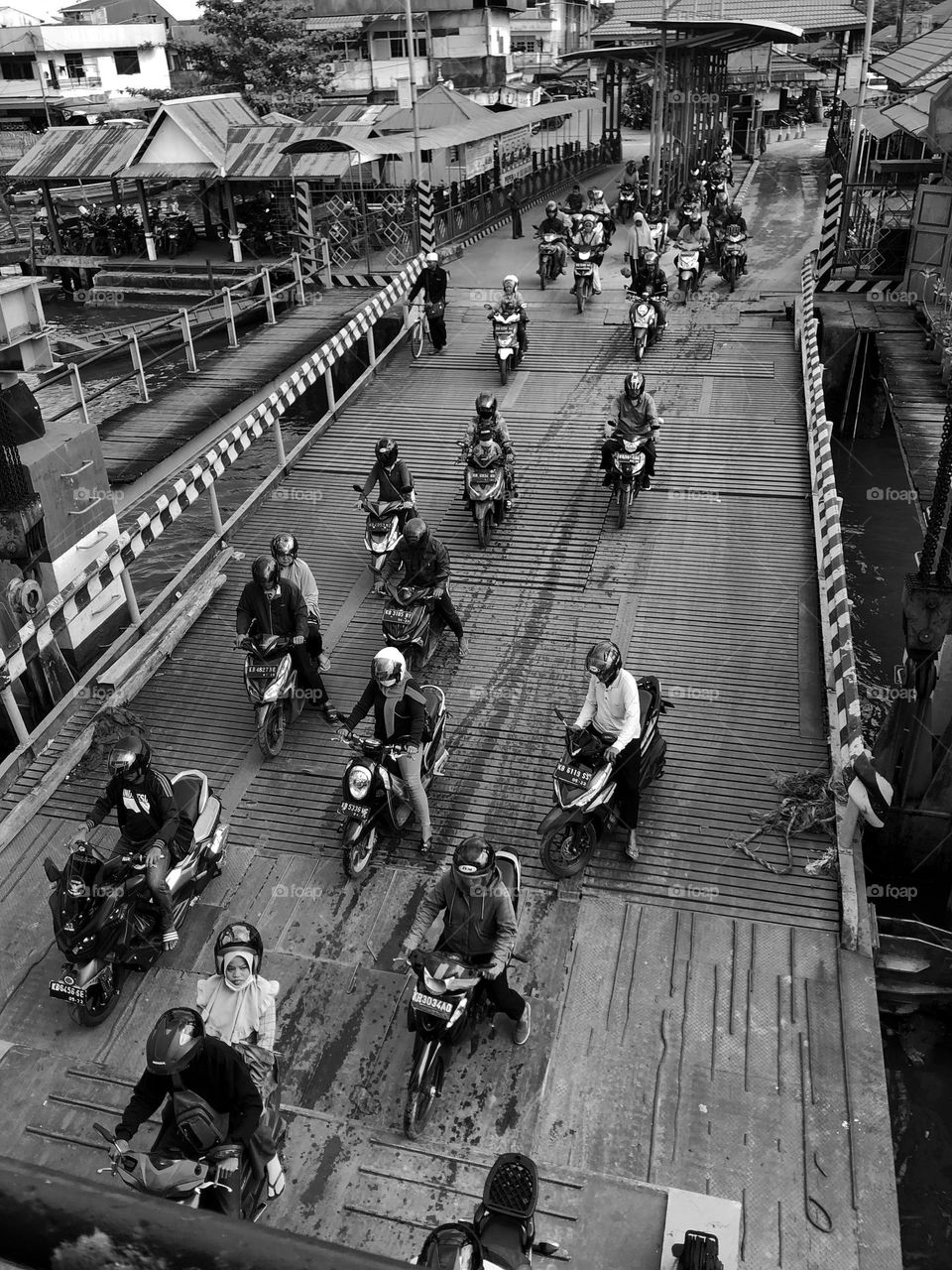 People riding motorcycle in the bridge 