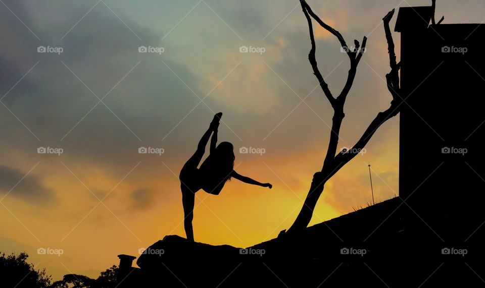 Silhouette of women doing yoga