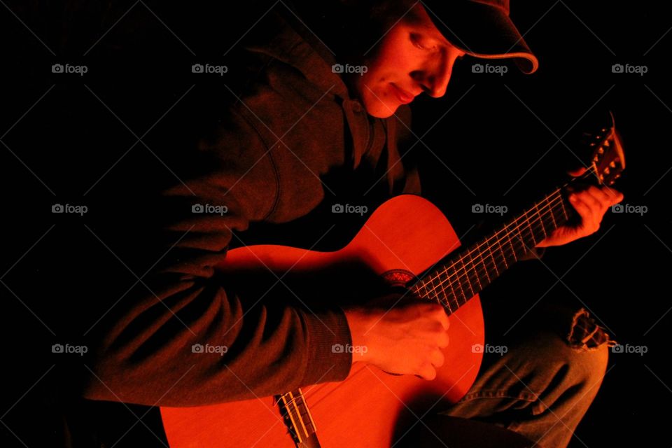Close-up of a man playing guitar
