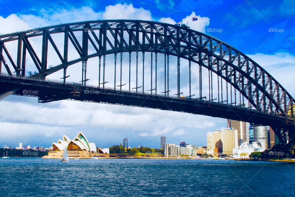 Sydney harbour bridge above the Sydney opera house in the sun in winter in Australia. 