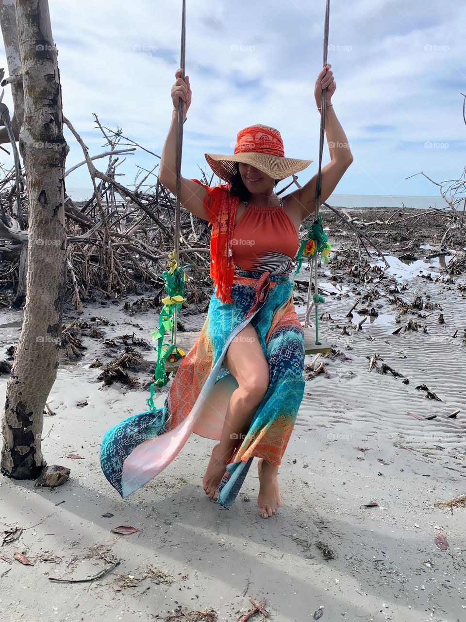 Woman on swing at the beach