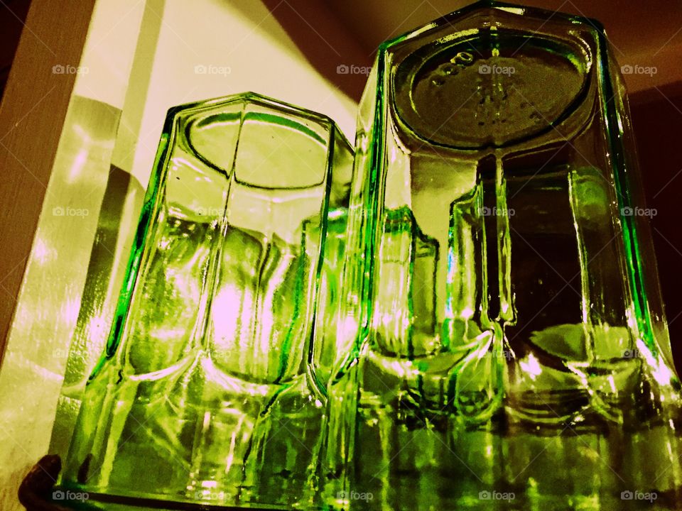 Close-up of two empty green glasses