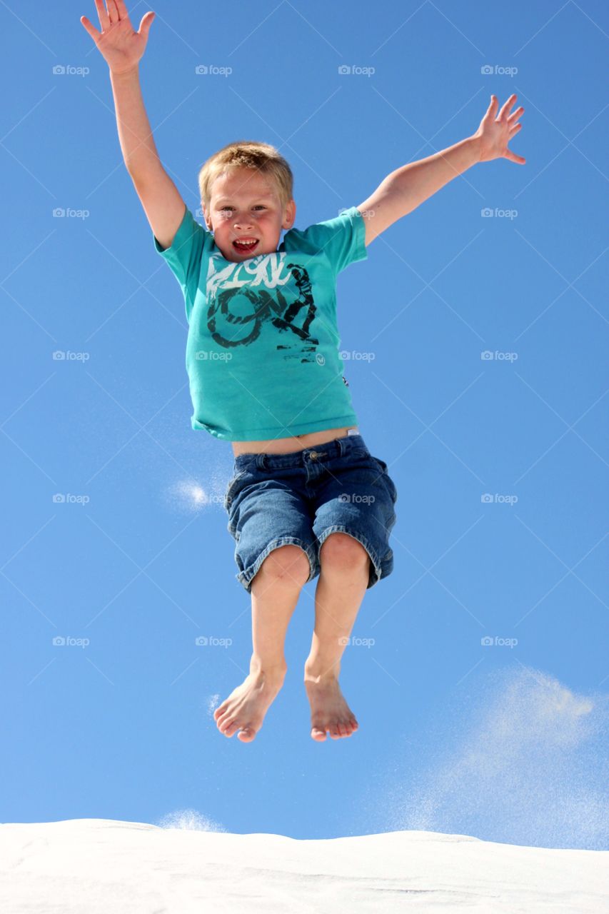 Small boy enjoying in snowy landscape