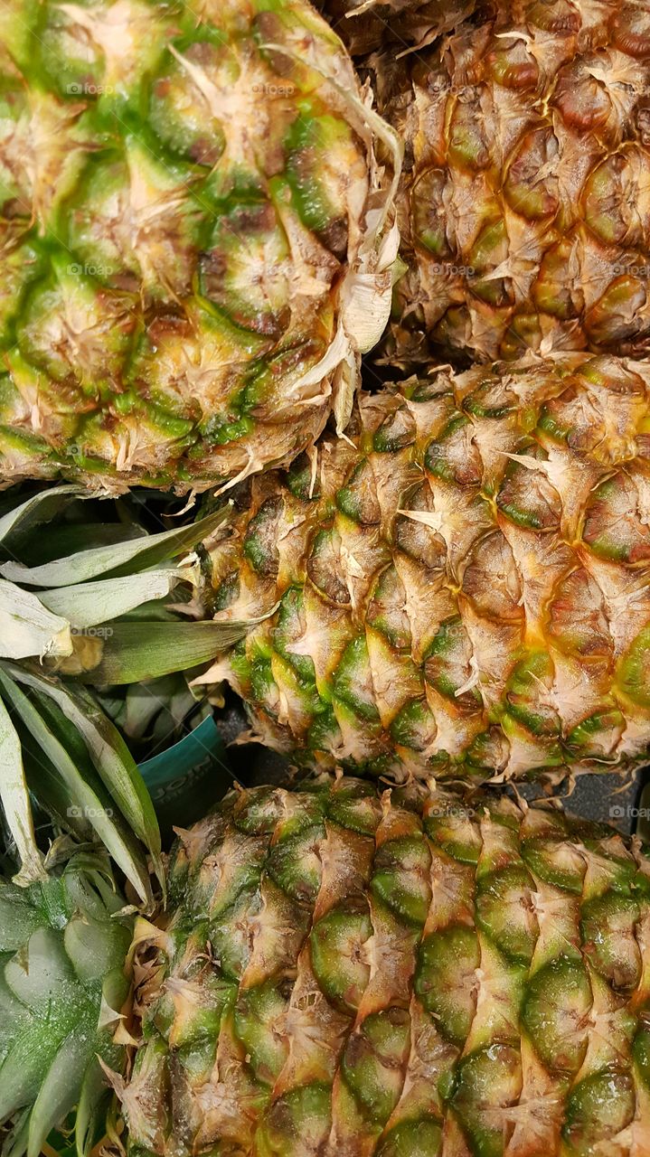 a pile of pineapples waits to be turned into a pineapple upside down cake