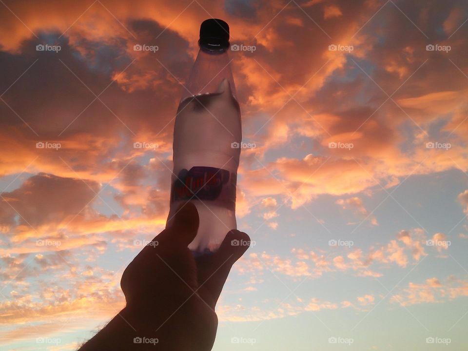 Magic sunset and a beautiful bottle embraces high sky.