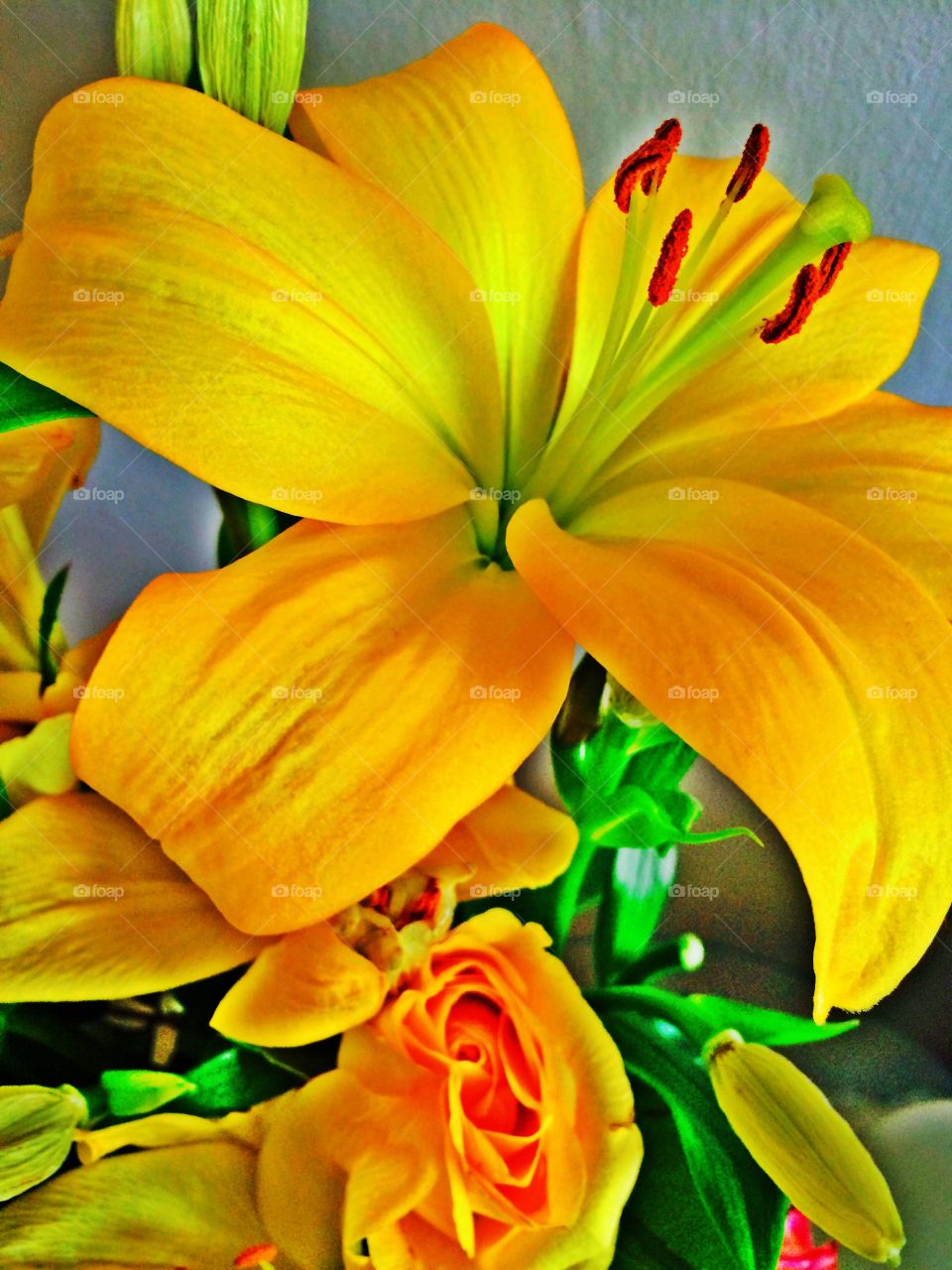 Yellow lillies and roses