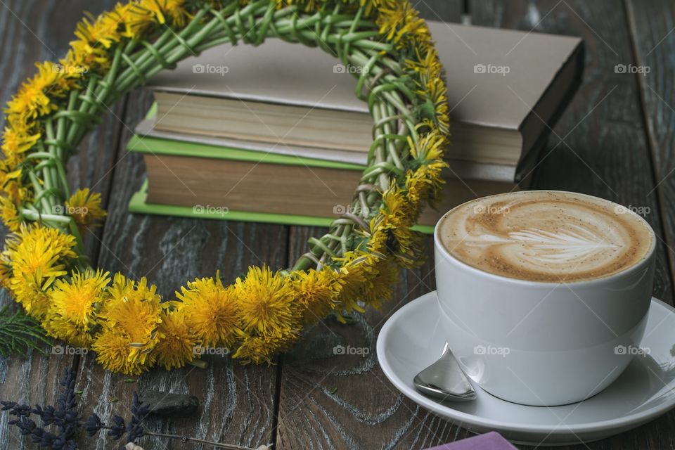 Coffee on table with book