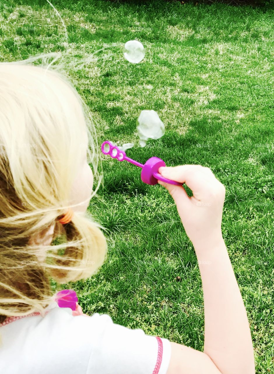 Child Blowing Bubbles