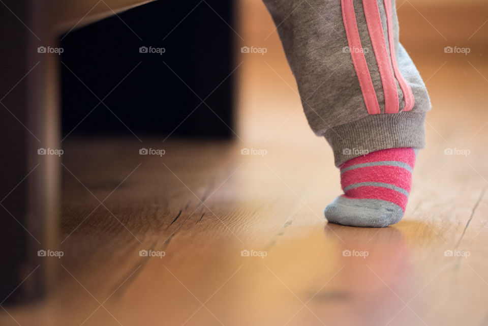 Bbay girl walking on wooden floor