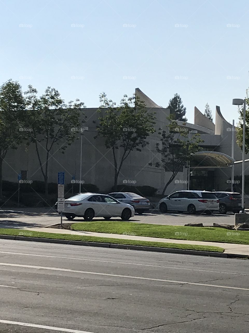 A vehicle entering the parking lot of the county public library.