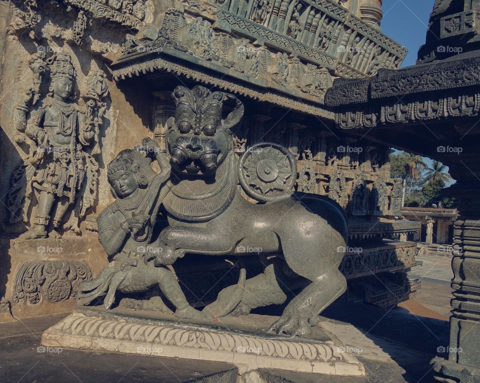 Hoysala  sculpture - the flag symbol - a man hunting a lion - satavahana dynasty 