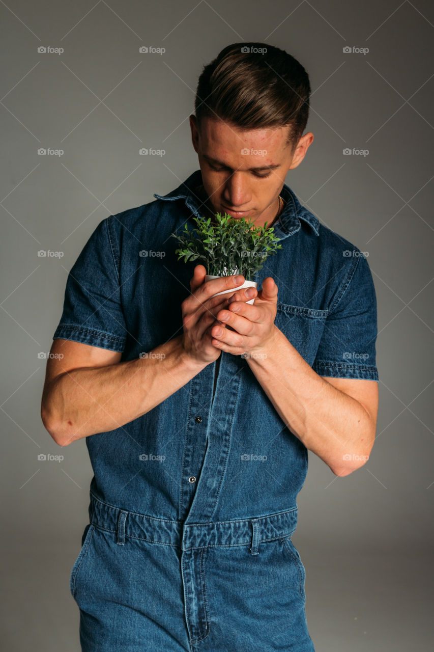 Men holding a plant