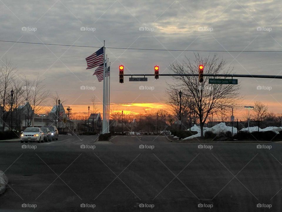 sunrise at intersection and flags