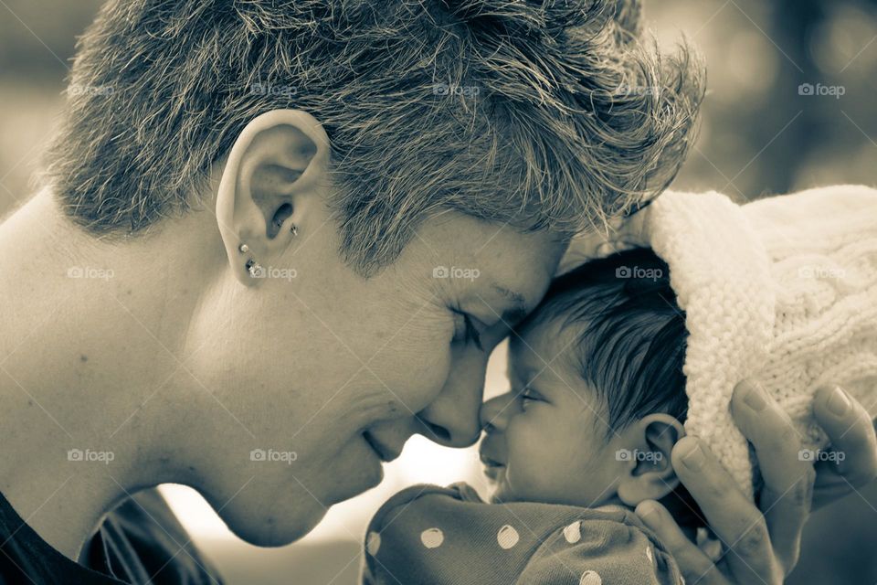 Mother with newborn daughter, nose to nose with daughter, mother loves baby, tender moments with newborn, baby with mother, showing love to daughter 