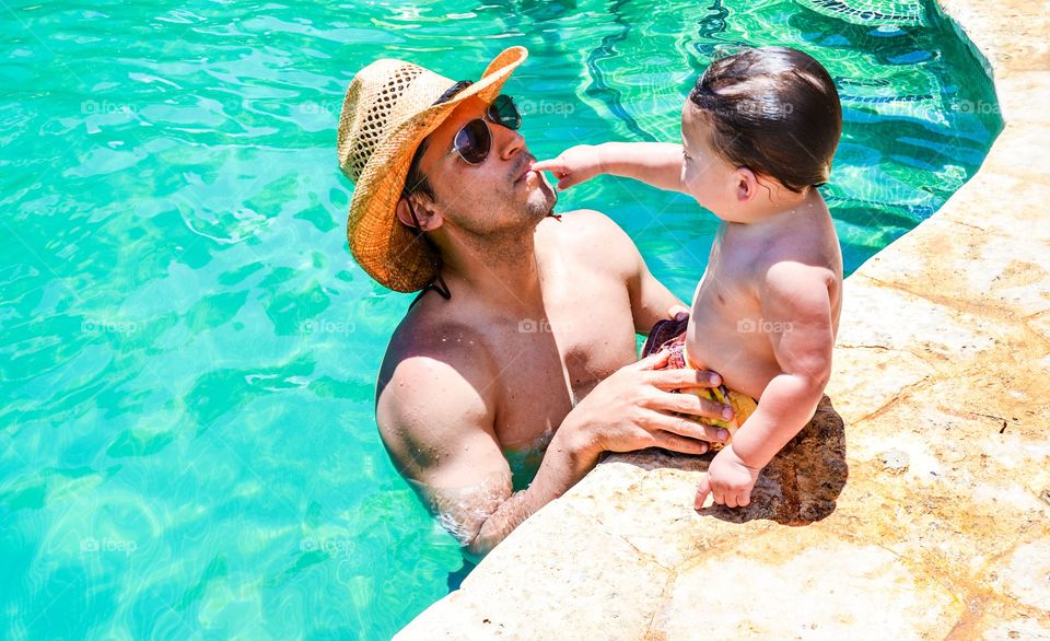 Father with daughter at swimming pool