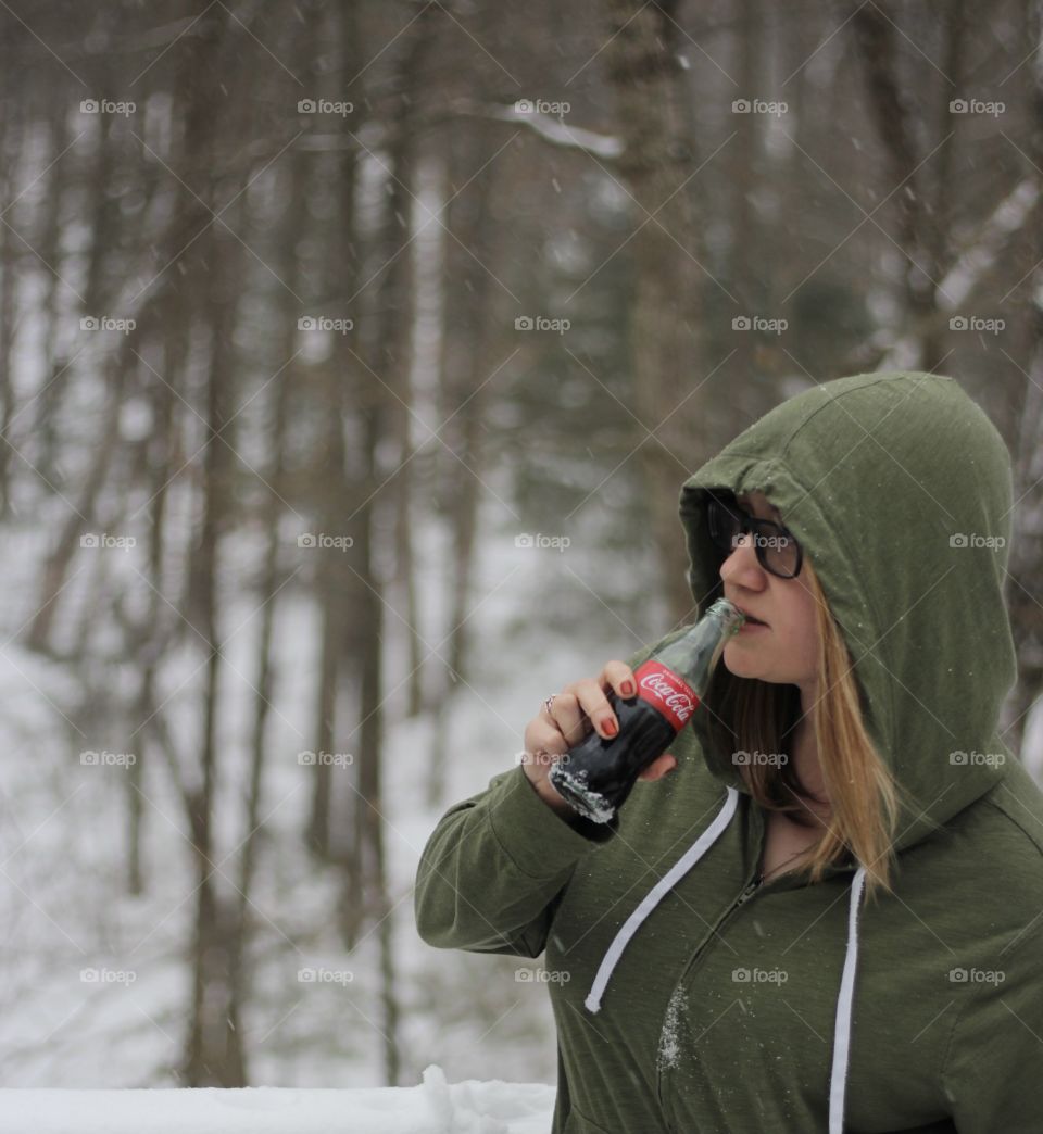 Woman drinking in Snowy woodlands 