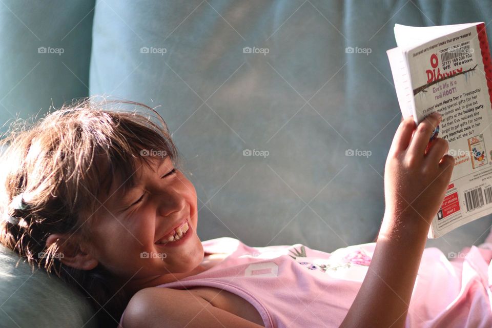 Cute little girl with a  
book