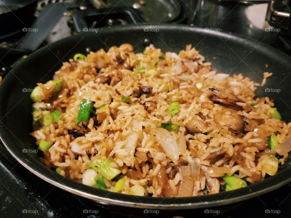 Exquisite mongolian vegetarian mushroom fried rice with caramelized onions