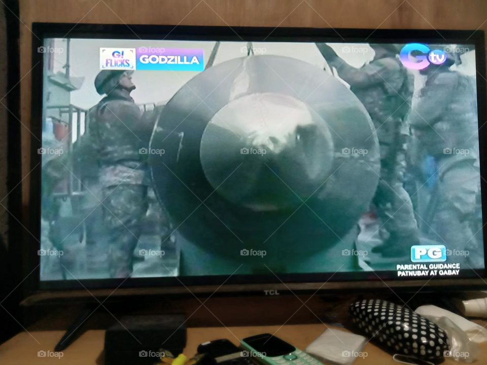 WATCHING MOVIE, GODZILLA,, SOLDIERS ARE PREPARING THE HUGE MISSILE TO LAUNCH AGAINST THE ENEMY OF GODZILLA,, WATCH OUT