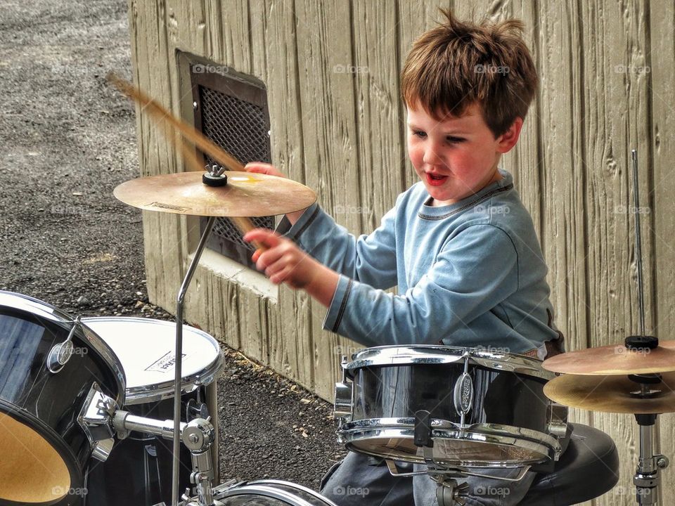 Young Boy Playing The Drums