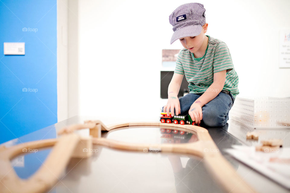 Boy building a train on a table