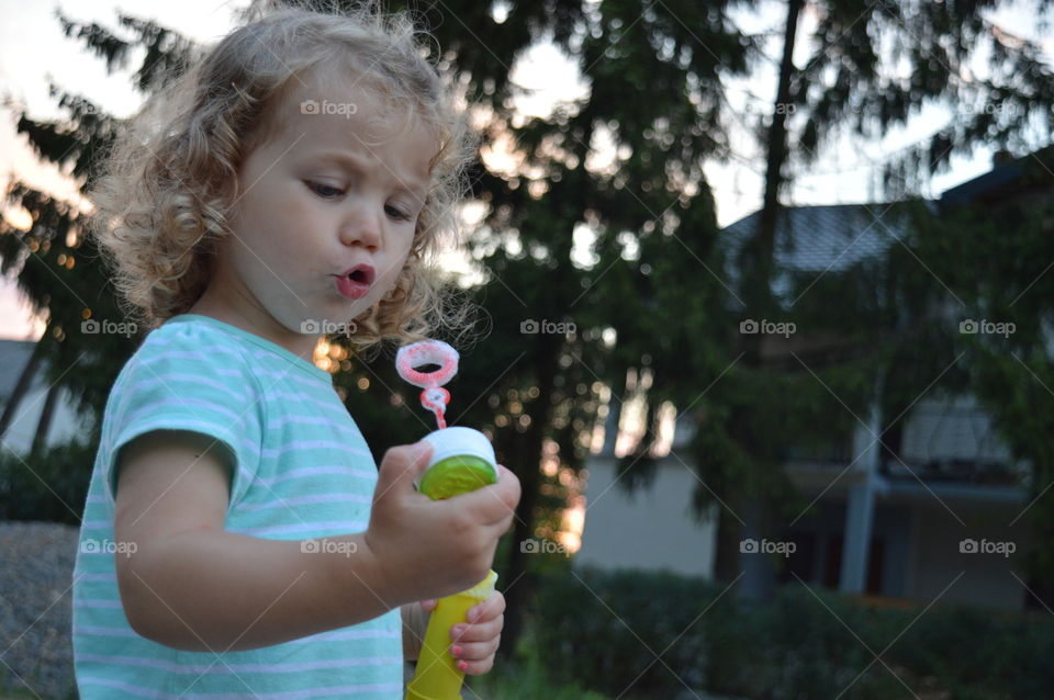 Girl trying to makes bubbles