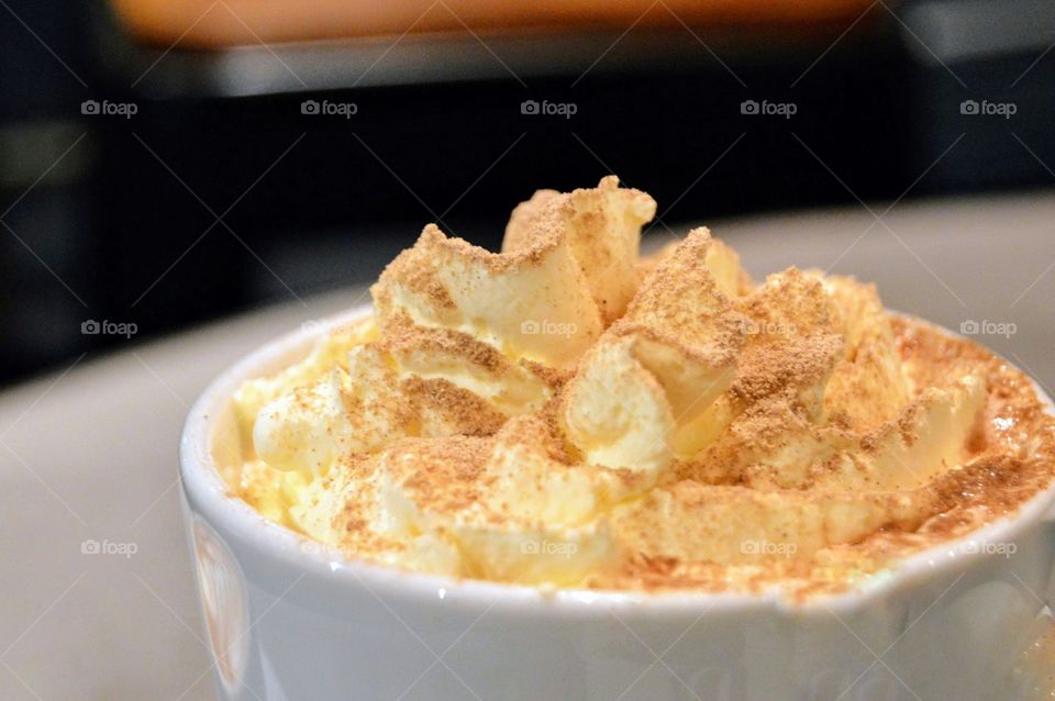 Latte with cinnamon and cream