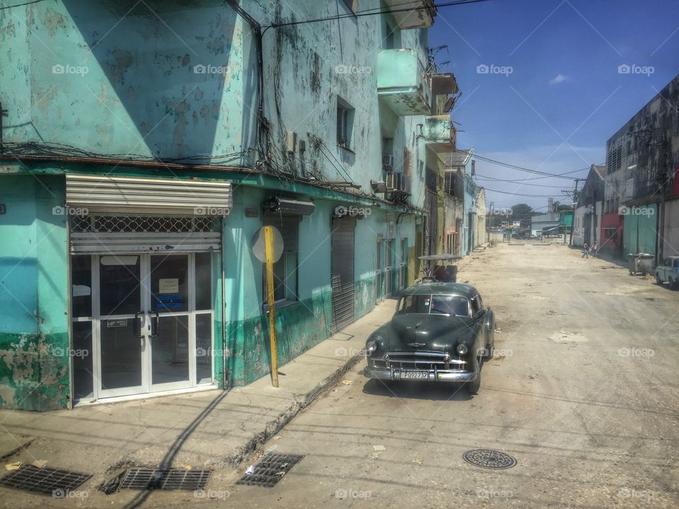 Cuban street scene with vintage car