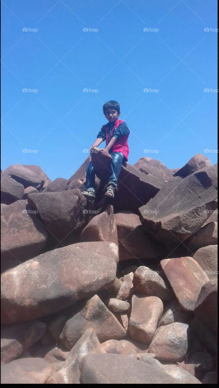 child playing on rocks