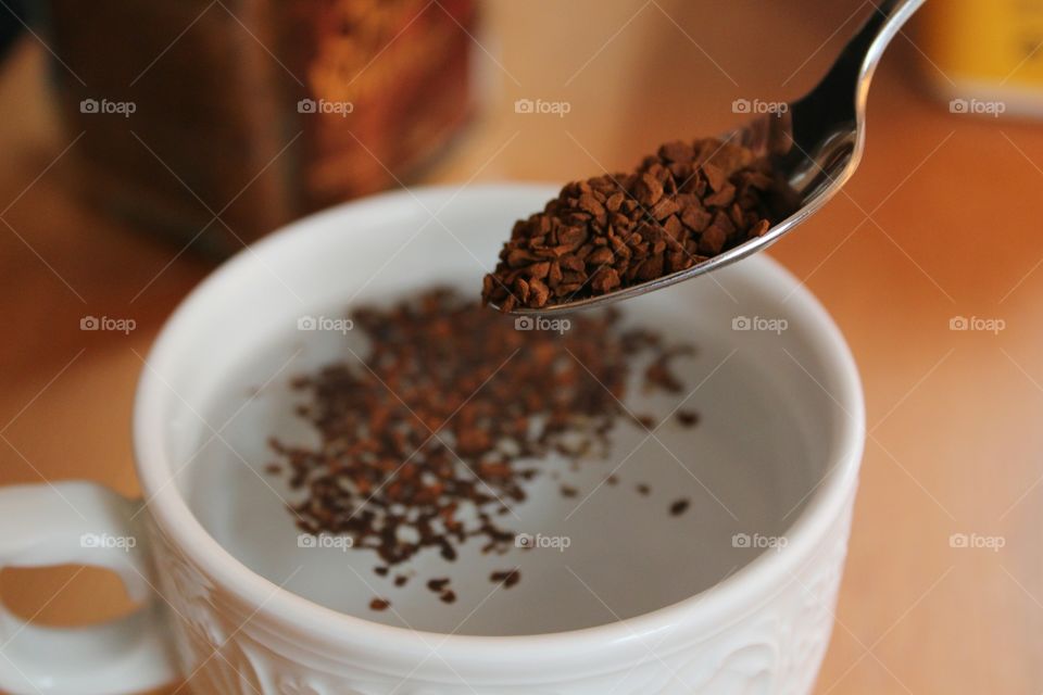 Ground coffee putting in milk